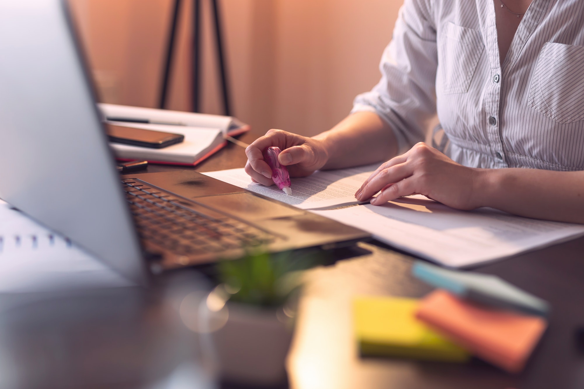 Businesswoman using an ink corrector